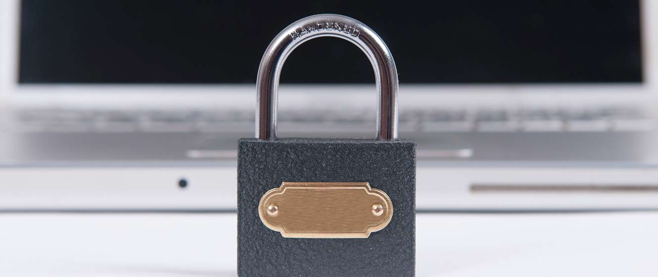Image of lock sitting in front of laptop.