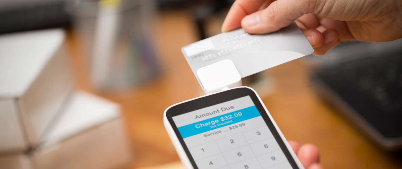 Image of customer swiping card on smartphone using card reader
